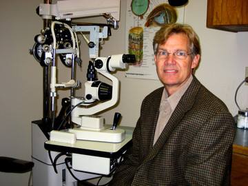 Dr. Don Walker optometrist at Lusk Eye Specialist with eye treatment machine