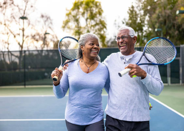 elderly couple happy after playing tennis with improved vision from cataract surgery at Lusk Eye Specialists