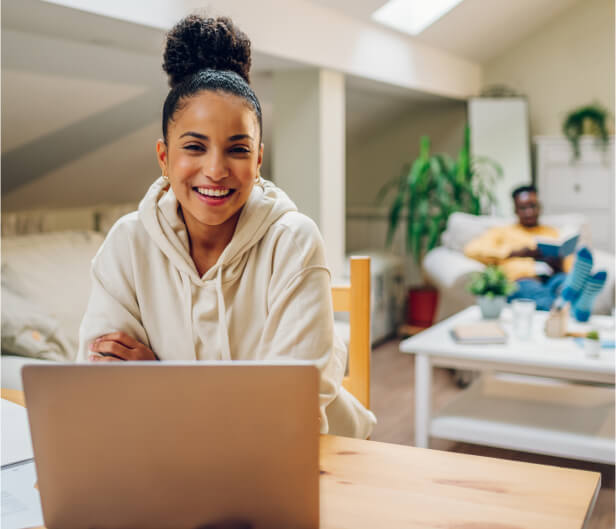 woman happy using laptop at Lusk Eye Specialists